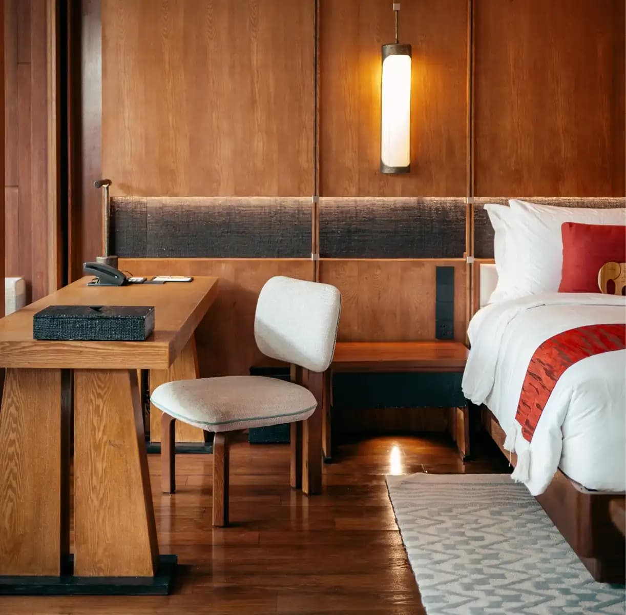 A warmly detailed guest room at Anantara Chiang Mai