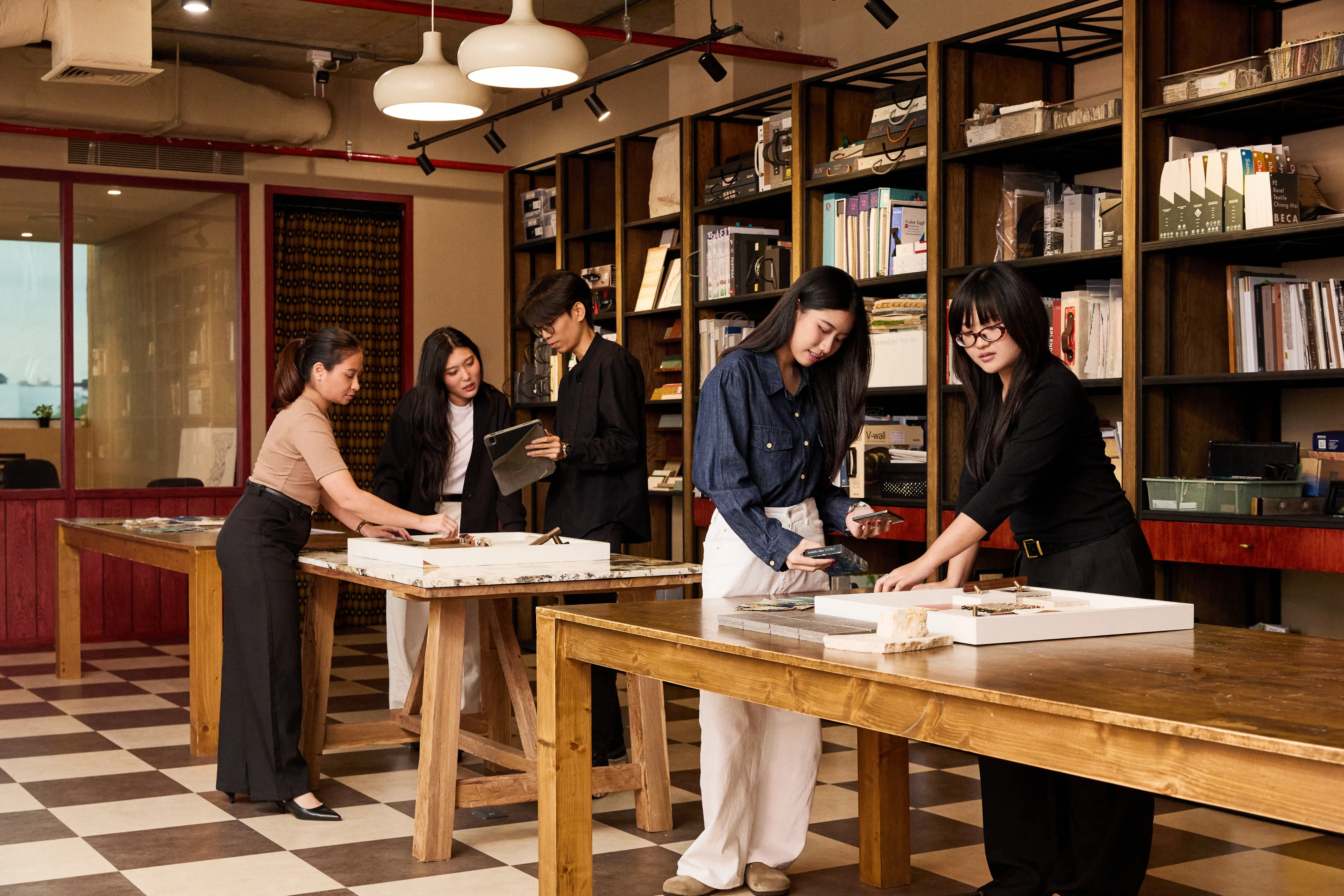 Team members inspecting architectural scale model