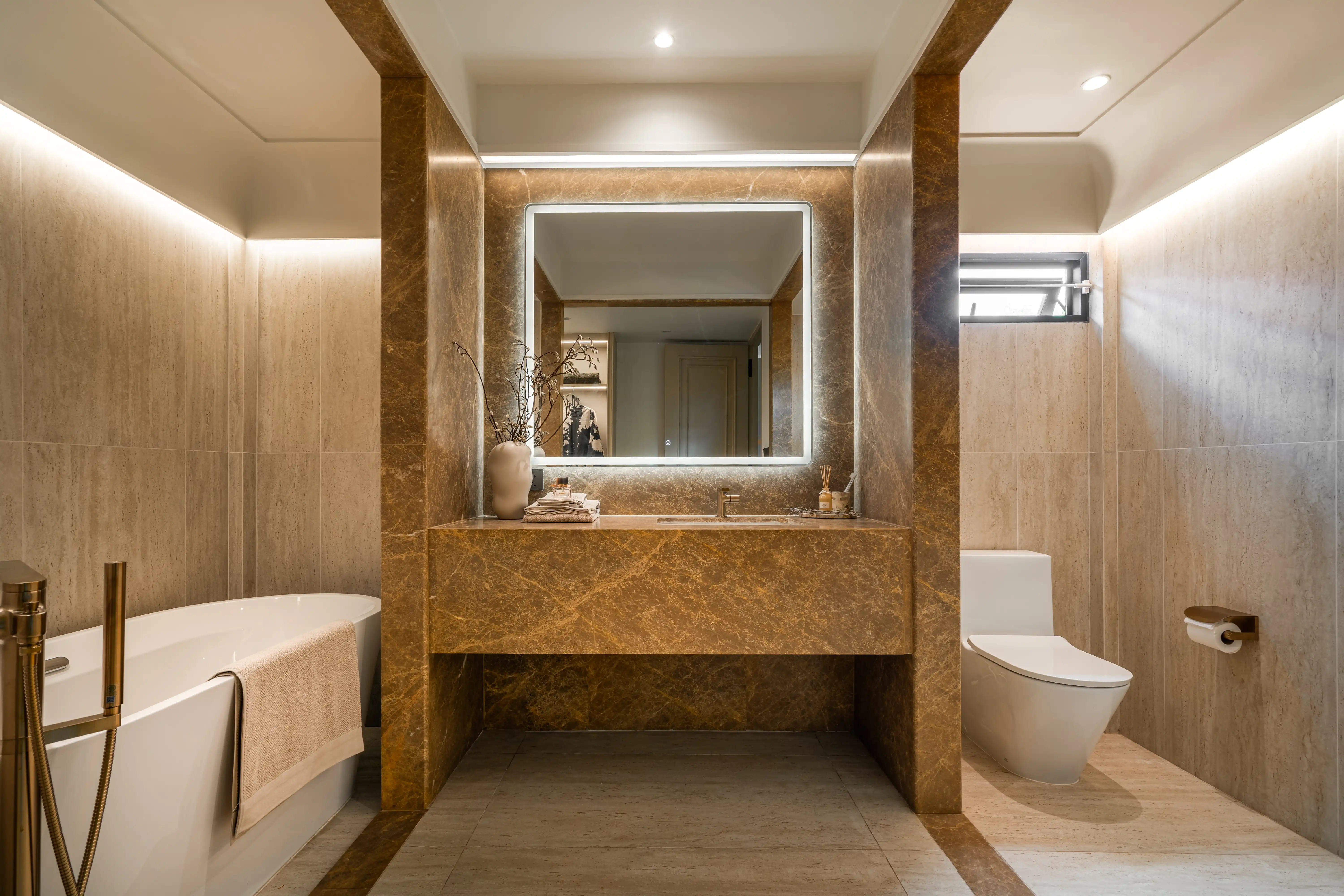 MASTER BATHROOM — AMBER MARBLE & BRASS FITTINGS
